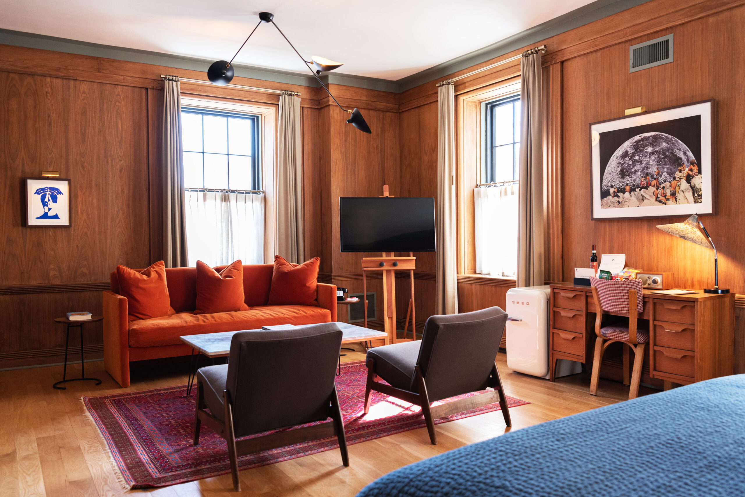 Boutique suite at Hotel Kinsley in Kingston, with warm wood paneling and a sitting area